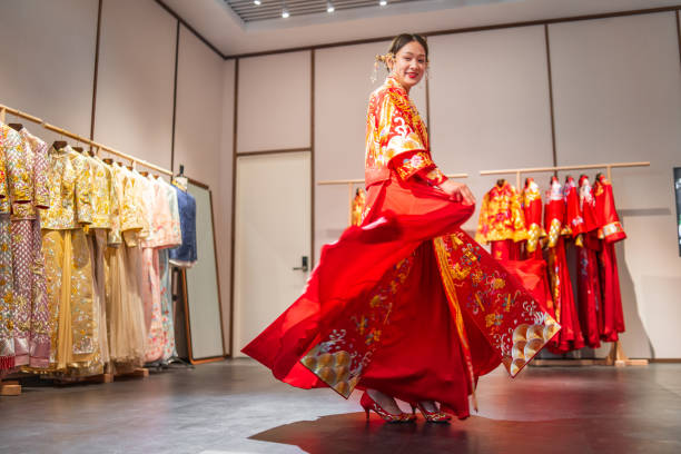 Young woman trying on a traditional wedding dress.