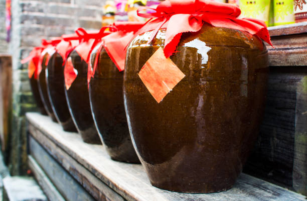 Homemade Chinese wine fermented with osmanthus flowers packed in traditional vats