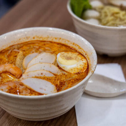 Laksa is a spicy noodle soup popular in Peranakan cuisine of Southeast Asia Singapore